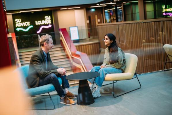 student talking to a mentor in One Elmwood student centre